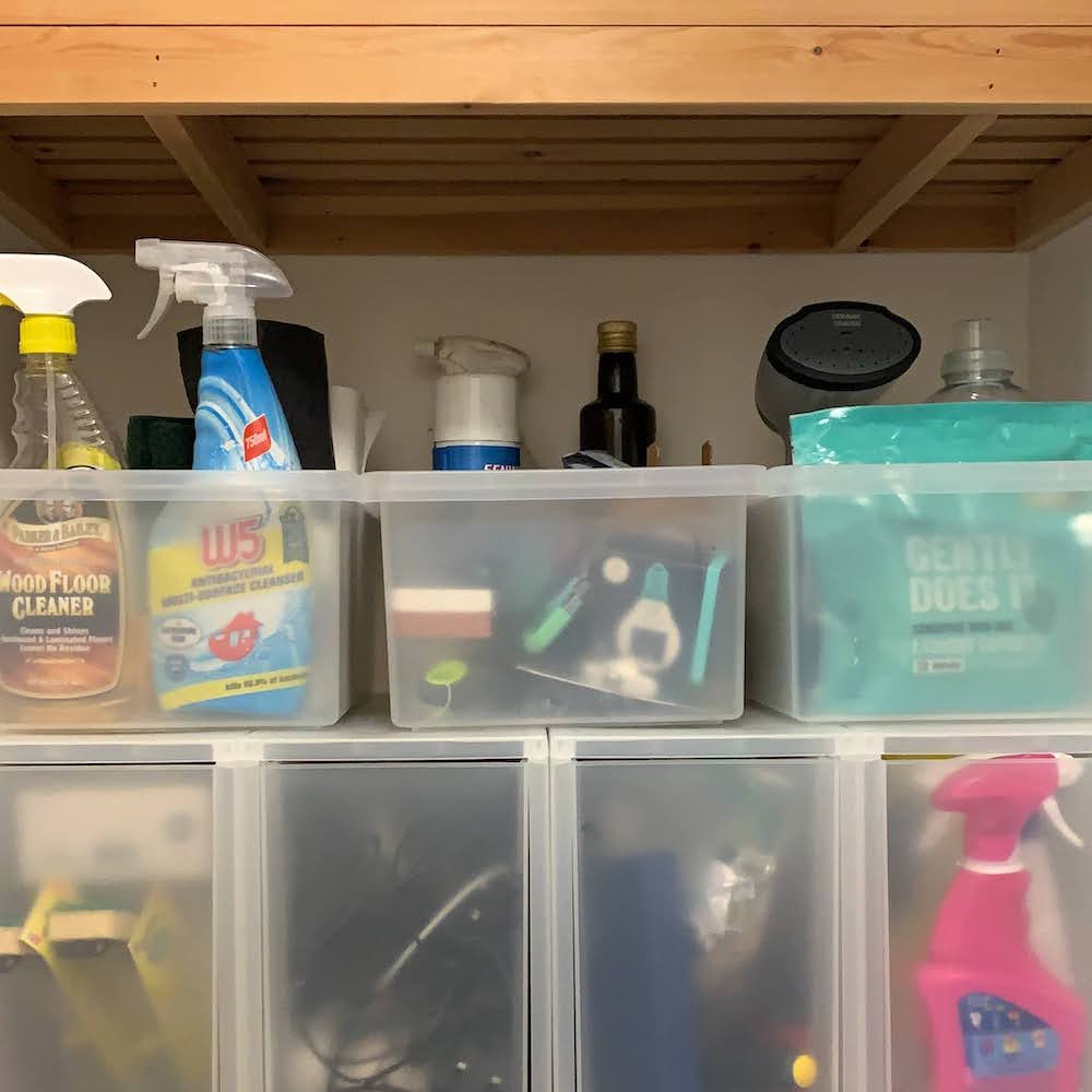 My highly un-eco-friendly cleaning cupboard before I started, including washing tabs, fabric cleaner, wood floor cleaner